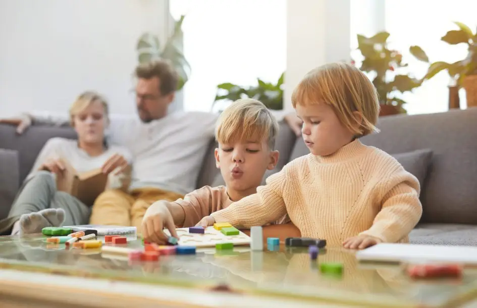blonde boy playing with little sister while enjoying time with family at home, counting activities for preschoolers