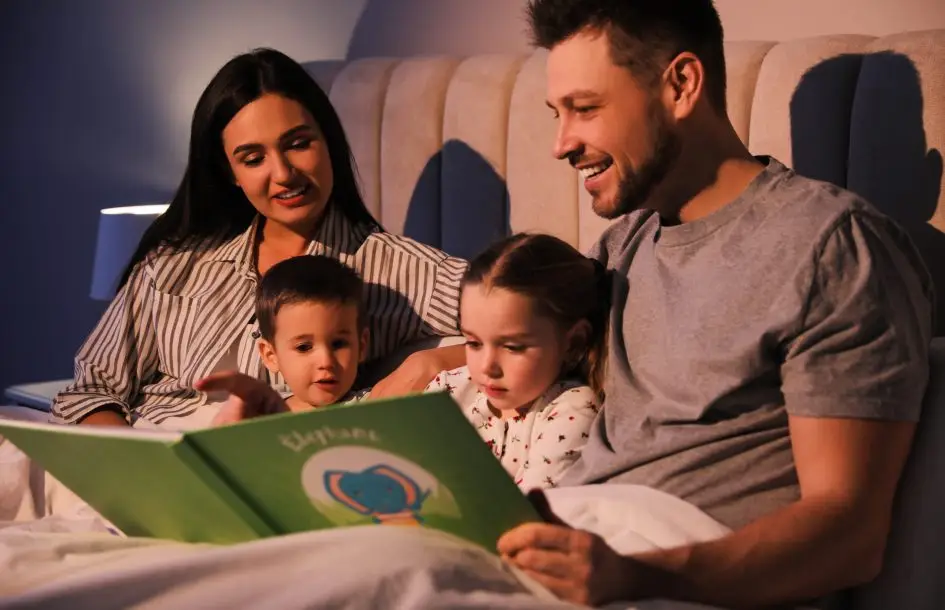 family- reading night ideas. Family reading book together in bed at home