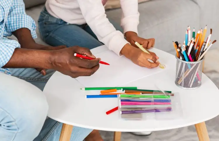 summer crafts for kids. dad and daughter close up, hands drawing