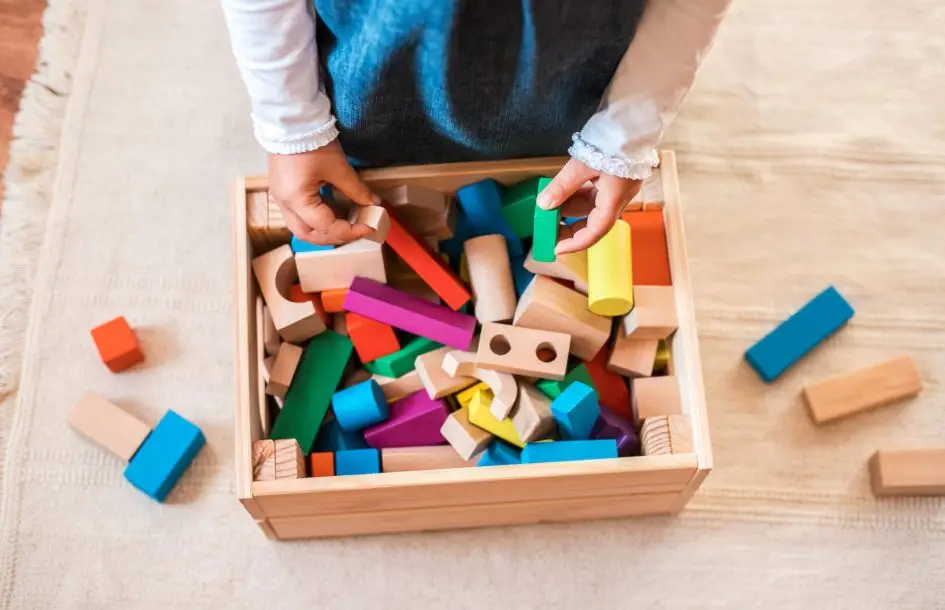 little girl zoomed in playing with blocks. what children actually learn from blocks